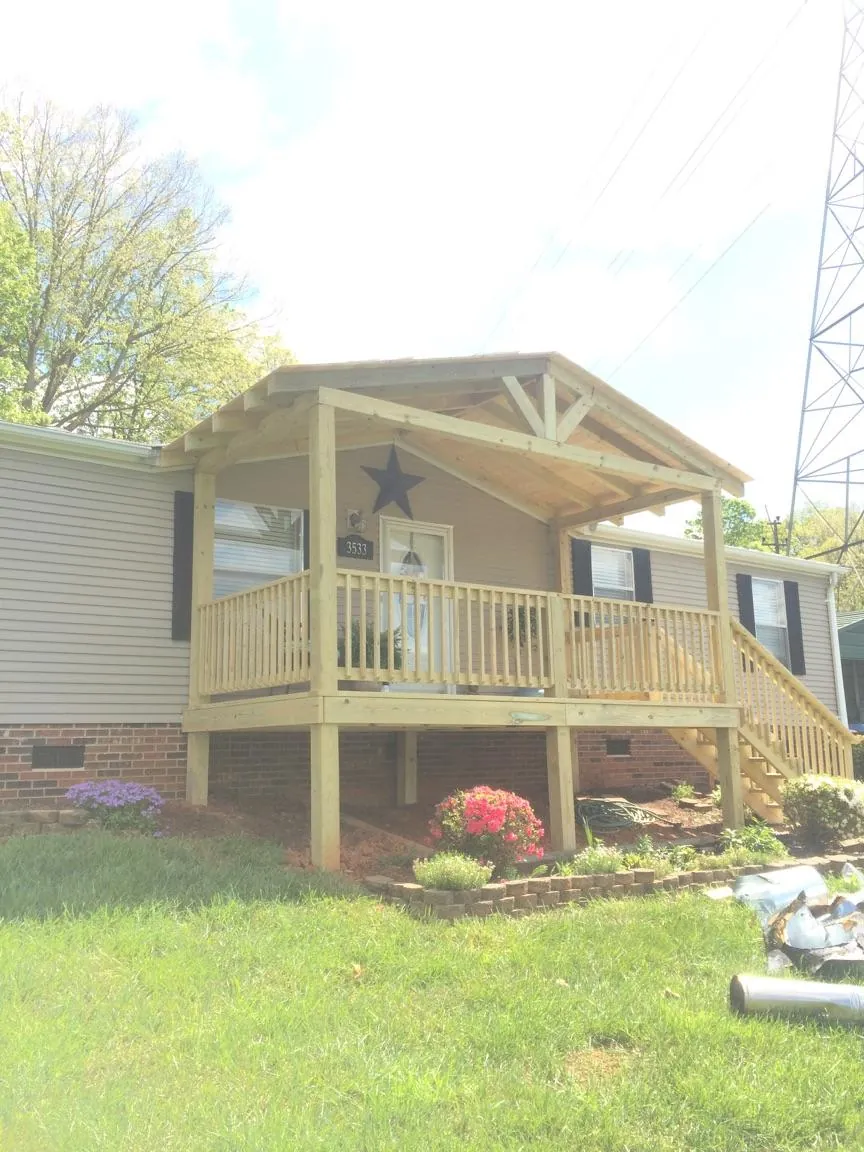 New gabled porch roof and deck railing added to a ranch home in Union